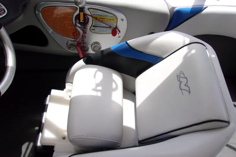 Slide: The Image of 2005 Correct Craft 210 SUPER AIR TEAM EDITION boat interior with white and blue seating. - 5