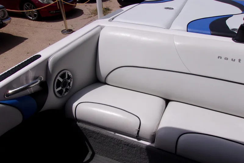 Slide: The Image of 2005 Correct Craft 210 SUPER AIR TEAM EDITION boat interior with white seating and speaker. - 7