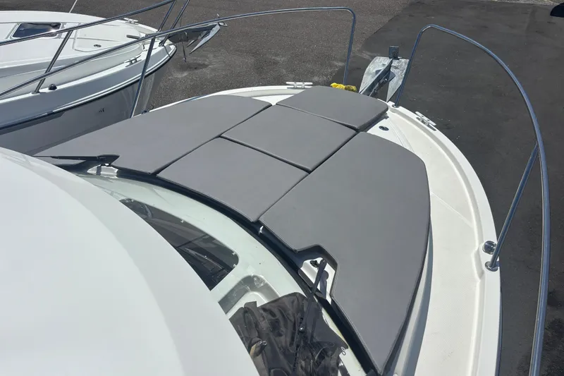Slide: The Image of 2021 Beneteau Antares 8 boat with cushioned bow seating area. - 13
