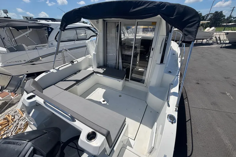 Slide: The Image of 2021 Beneteau Antares 8 boat with spacious deck and seating area. - 3