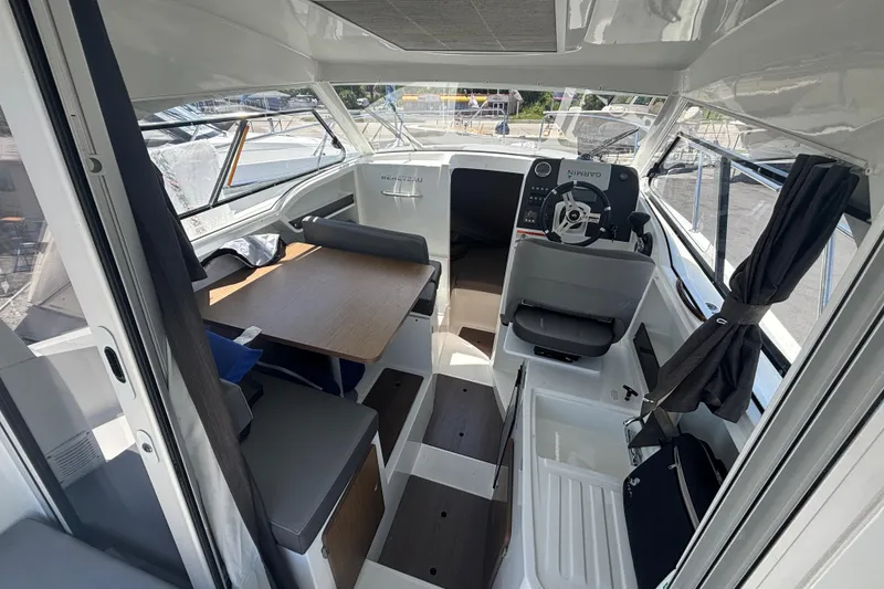 Slide: The Image of Interior of 2021 Beneteau Antares 8 boat, featuring helm and seating area. - 5