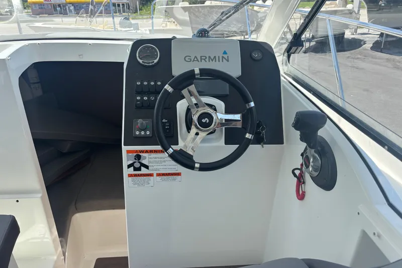 Slide: The Image of Cockpit of 2021 Beneteau Antares 8 with Garmin navigation system and steering wheel. - 6