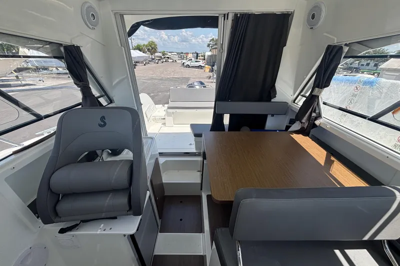 Slide: The Image of Interior of 2021 Beneteau Antares 8 boat with seating and table. - 7