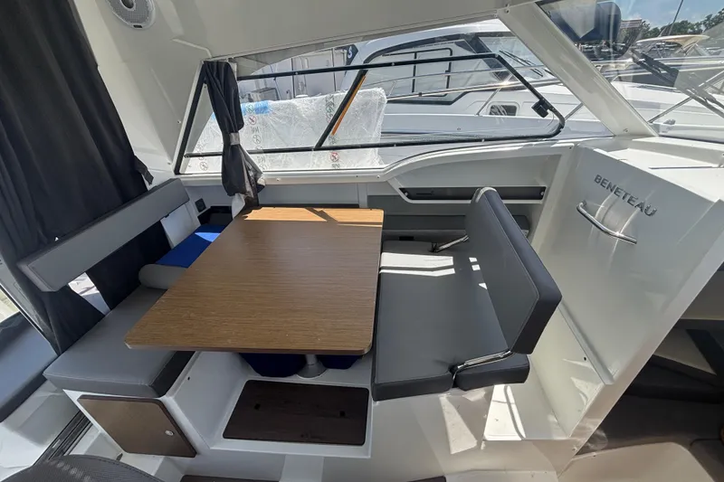 Slide: The Image of Interior of 2021 Beneteau Antares 8, featuring a cozy dining area with wooden table. - 9