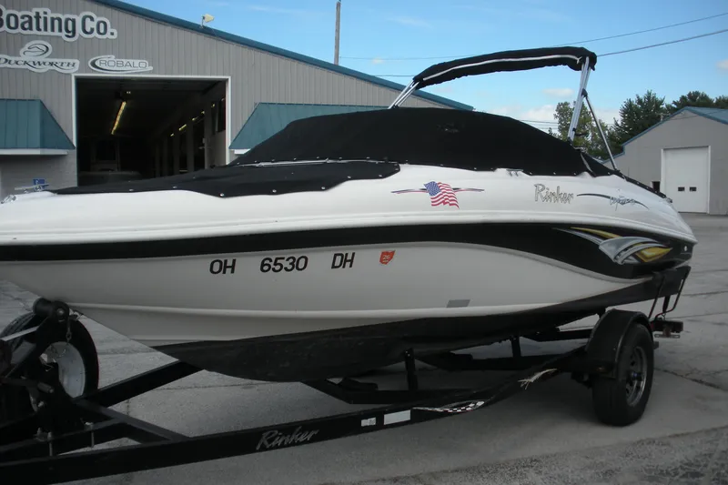 Slide: The Image of 2003 Rinker 192 Captiva Bowrider boat on trailer outside a boating company. - 1