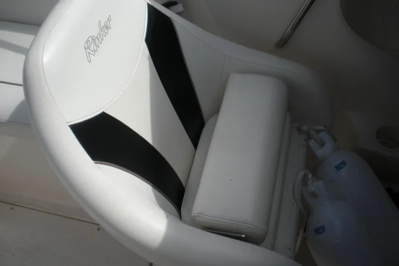 Slide: The Image of 2003 Rinker 192 Captiva Bowrider seat with black and white design. - 10