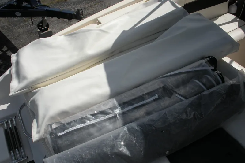 Slide: The Image of 2003 Rinker 192 Captiva Bowrider interior with covered equipment and accessories. - 12