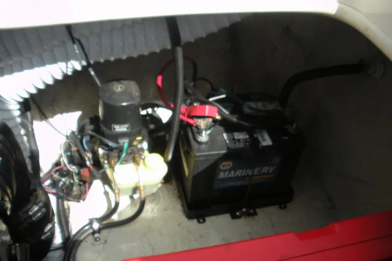 Slide: The Image of 2003 Rinker 192 Captiva Bowrider engine compartment with battery and wiring. - 13