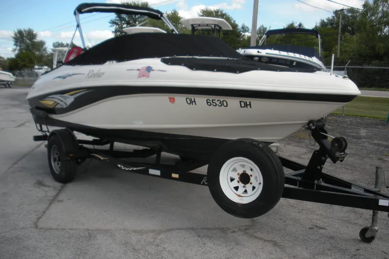 Slide: The Image of 2003 Rinker 192 Captiva Bowrider on trailer, parked outdoors. - 2