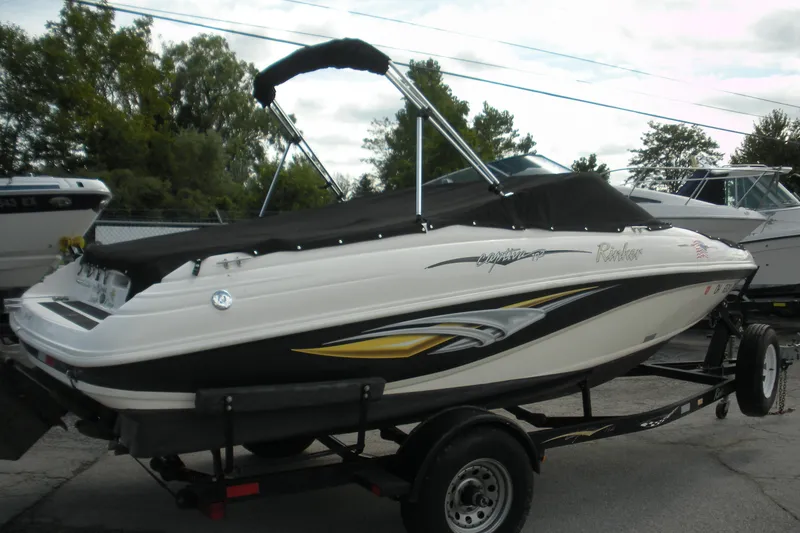 Slide: The Image of 2003 Rinker 192 Captiva Bowrider boat on trailer, covered and parked outdoors. - 3