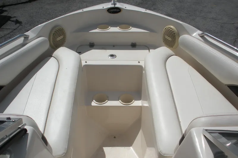 Slide: The Image of 2003 Rinker 192 Captiva Bowrider interior with white seating and cup holders. - 4