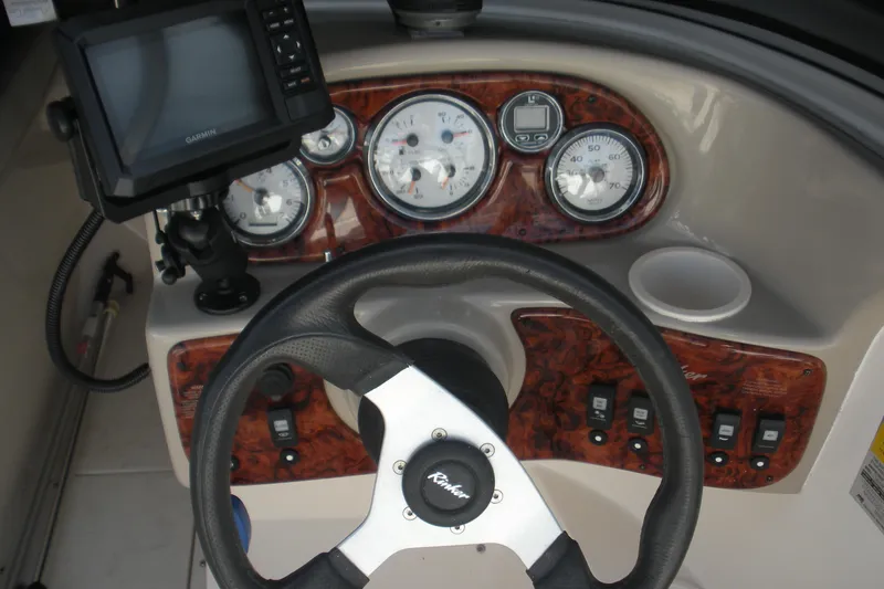 Slide: The Image of Dashboard of a 2003 Rinker 192 Captiva Bowrider with steering wheel and gauges. - 5