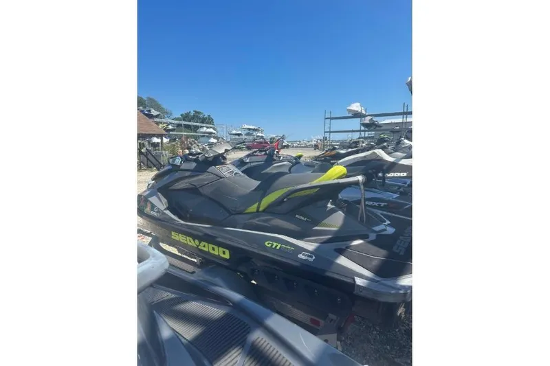 Slide: The Image of 2015 Sea-Doo GTI Limited 155 jet ski parked outdoors under clear blue sky. - 10