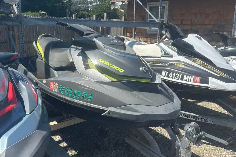 Slide: The Image of 2015 Sea-Doo GTI Limited 155 jet ski parked on a trailer in a lot. - 3