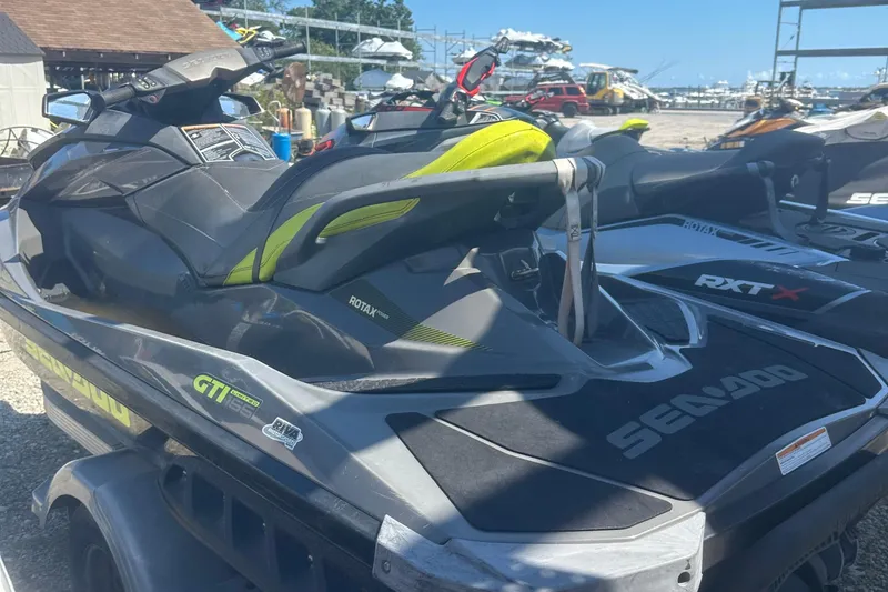 Slide: The Image of 2015 Sea-Doo GTI Limited 155 jet ski parked outdoors on a trailer. - 5