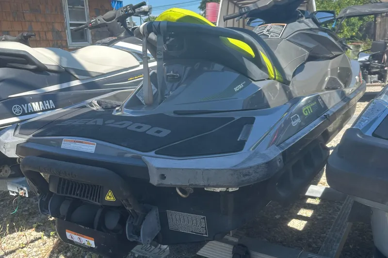 Slide: The Image of 2015 Sea-Doo GTI Limited 155 jet ski parked beside a Yamaha watercraft. - 6