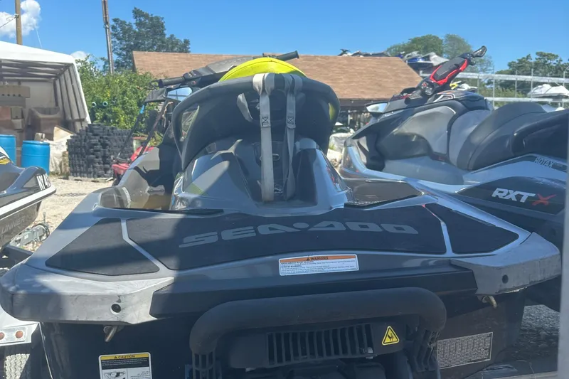 Slide: The Image of 2015 Sea-Doo GTI Limited 155 jet ski parked outdoors, rear view. - 8