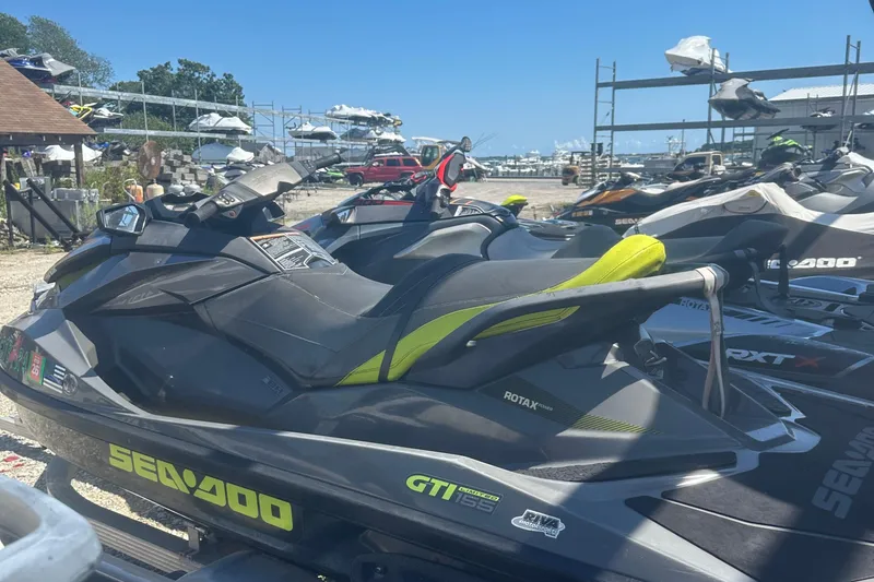Slide: The Image of 2015 Sea-Doo GTI Limited 155 jet ski parked in a marina storage area. - 9