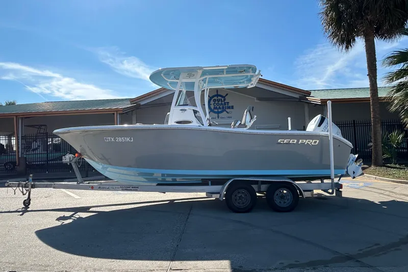 The Image of 2021 Sea Pro 239 Center Console boat on trailer, parked outdoors under clear sky. - 0