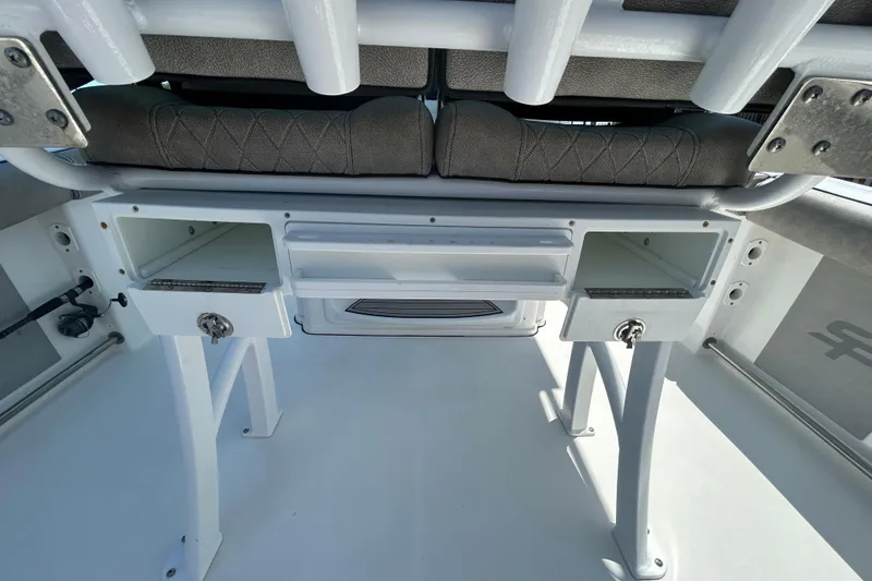Slide: The Image of 2021 Sea Pro 239 Center Console boat interior with storage compartments and seating. - 10
