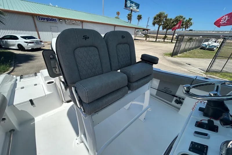 Slide: The Image of 2021 Sea Pro 239 Center Console boat with dual gray seats and steering console. - 11