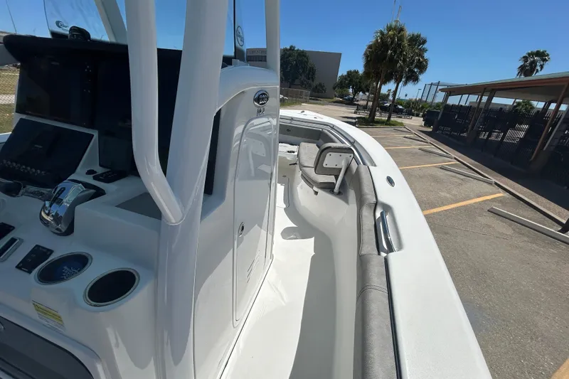 Slide: The Image of 2021 Sea Pro 239 Center Console boat interior with seating and control panel. - 13