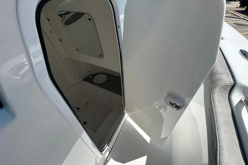 Slide: The Image of 2021 Sea Pro 239 Center Console boat interior storage compartment with open door. - 14