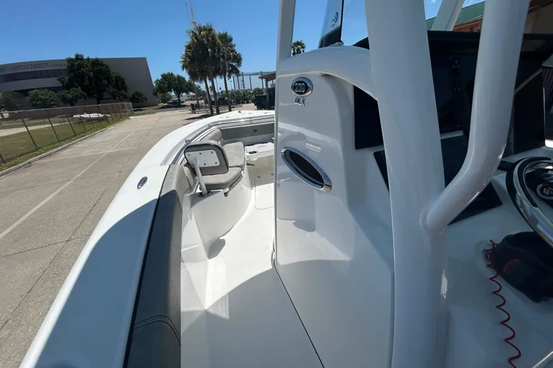 Slide: The Image of 2021 Sea Pro 239 Center Console boat, docked outdoors, showcasing sleek design and seating. - 15