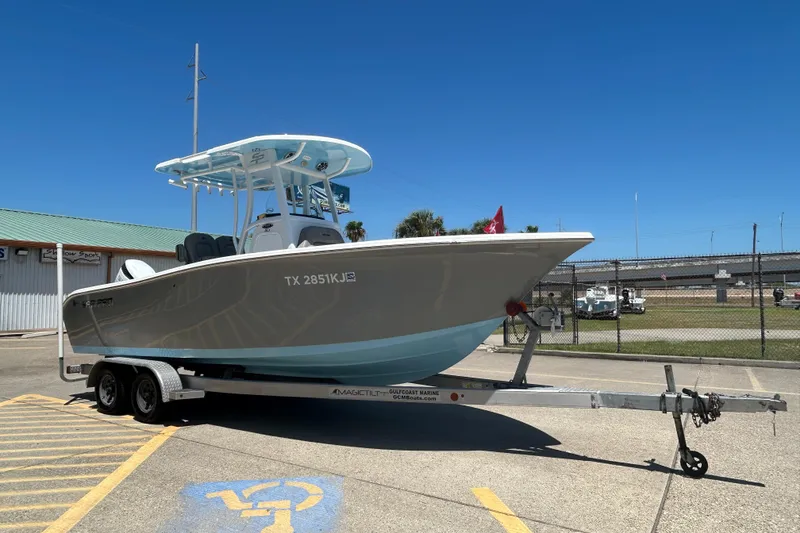 Slide: The Image of 2021 Sea Pro 239 Center Console boat on trailer, featuring powerful outboard motor. - 4