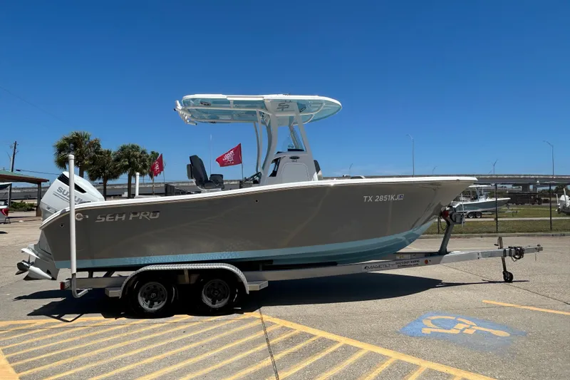 Slide: The Image of 2021 Sea Pro 239 Center Console boat on trailer, rear view, sunny day. - 5