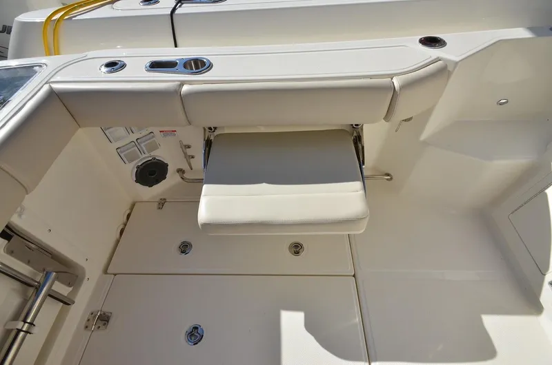 Slide: The Image of Manufacturer Provided Image: 2021 Boston Whaler 325 Conquest cockpit seating and storage area. - 16
