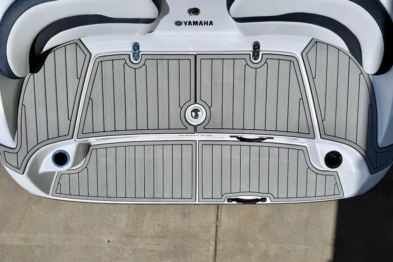 Slide: The Image of 2025 Yamaha Boats AR195 swim platform with gray decking and sleek design. - 10