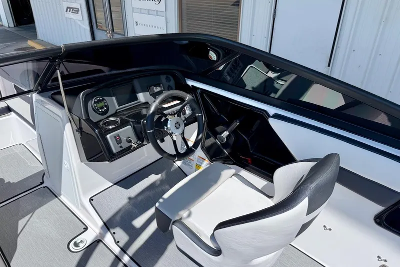 Slide: The Image of 2025 Yamaha AR195 boat cockpit with steering wheel and dashboard controls. - 12
