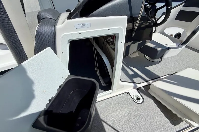 Slide: The Image of 2025 Yamaha AR195 boat interior with storage compartment and steering wheel. - 19