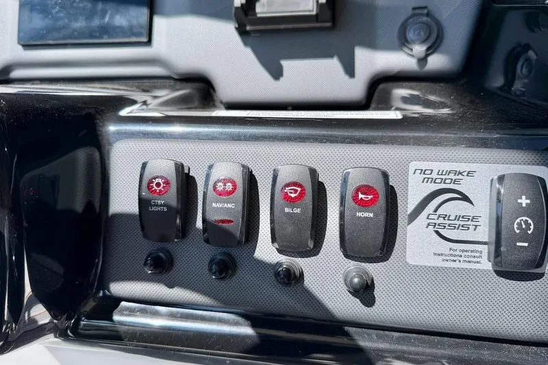 Slide: The Image of Control panel of 2025 Yamaha AR195 boat with various switches and cruise assist feature. - 23