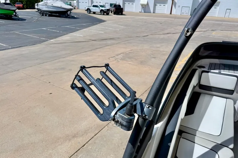 Slide: The Image of 2025 Yamaha AR195 boat with a wakeboard rack in a marina setting. - 27