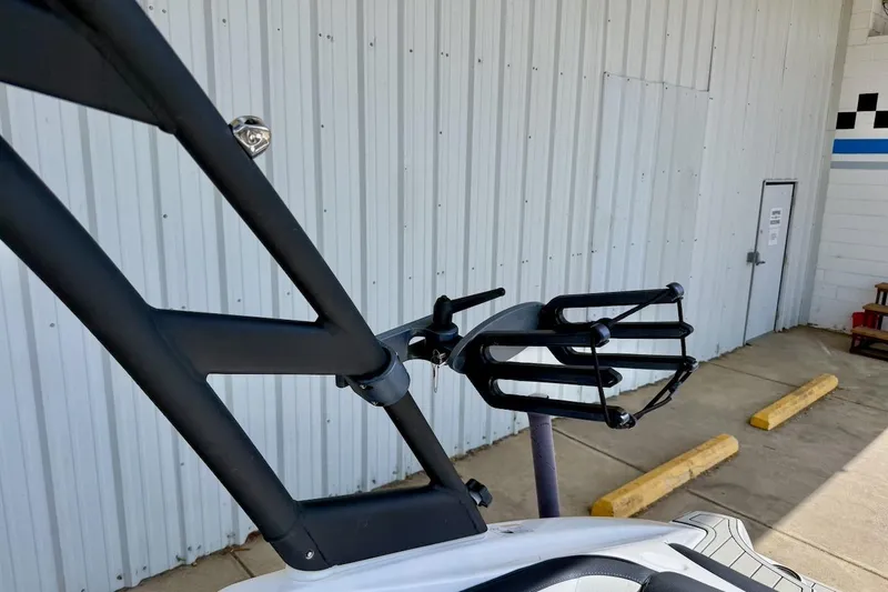 Slide: The Image of 2025 Yamaha Boats AR195 wakeboard rack against industrial building background. - 28