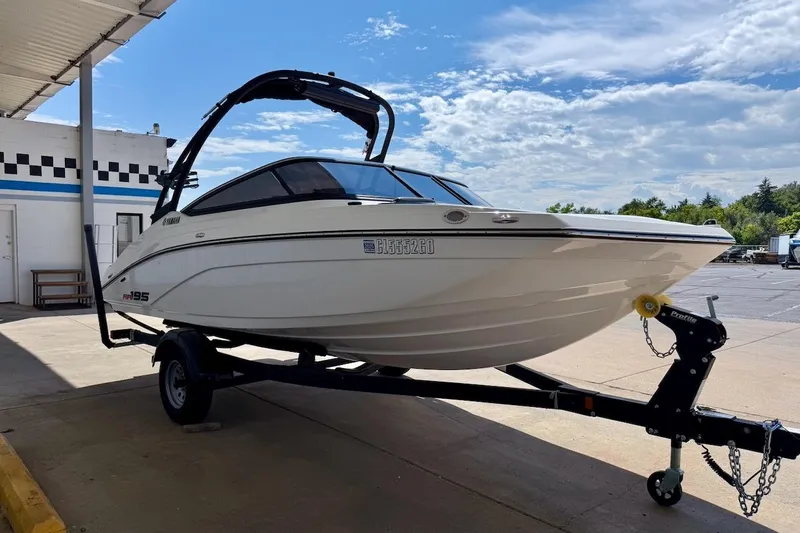 Slide: The Image of 2025 Yamaha Boats AR195 on trailer under a canopy, ready for transport. - 8