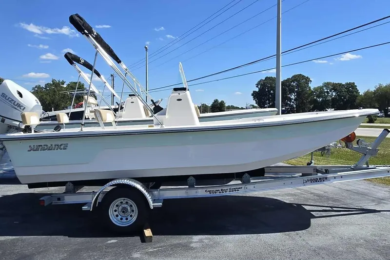 Slide: The Image of 2026 Sundance B20CCR boat on trailer, sunny day, clear blue sky. - 1