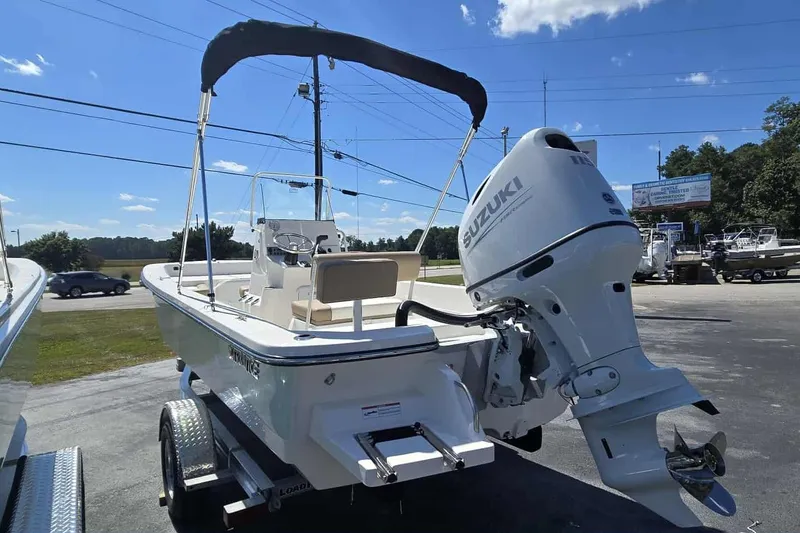 Slide: The Image of 2026 Sundance B20CCR boat with Suzuki outboard motor on a trailer, sunny day. - 3