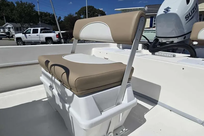 Slide: The Image of 2026 Sundance B20CCR boat seat with beige and white upholstery, Suzuki engine in background. - 5