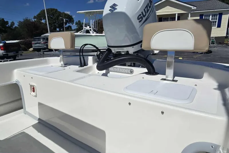 Slide: The Image of 2026 Sundance B20CCR boat with Suzuki engine, featuring dual seats and storage compartments. - 8