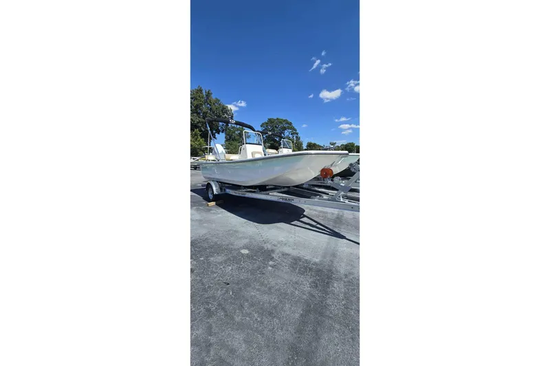 Slide: The Image of 2026 Sundance B20CCR boat on trailer under clear blue sky. - 9