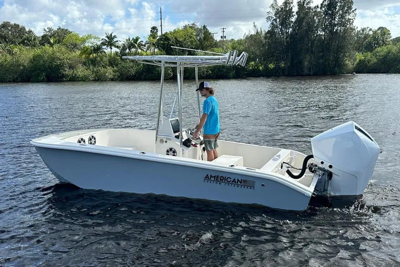 Slide: The Image of 2026 American Custom Catamarans 17LF on water, featuring sleek design and powerful outboard motor. - 4
