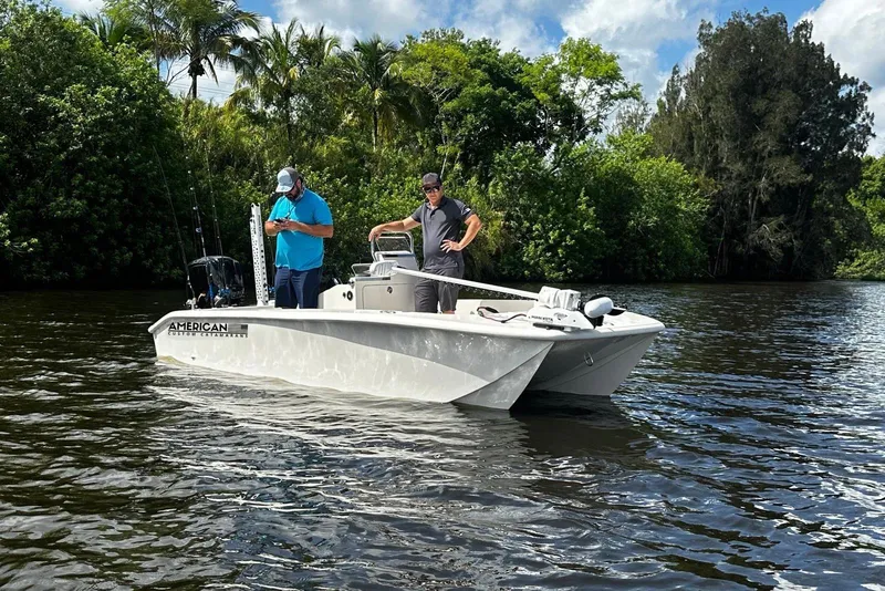 Slide: The Image of 2026 American Custom Catamarans 17LF on a scenic river with two people onboard. - 5