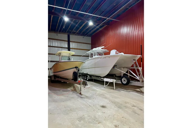 Slide: The Image of Two boats, including a 2023 Freeman 34VH, stored in a spacious indoor facility. - 12