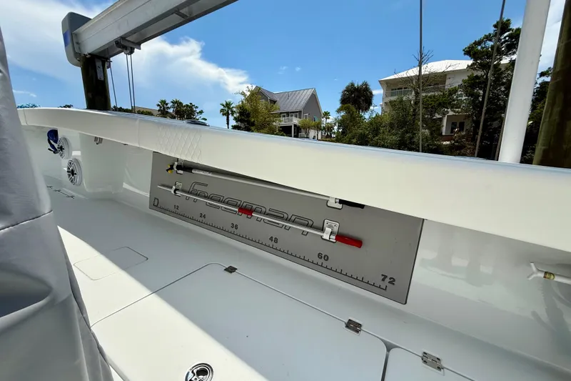 Slide: The Image of 2023 Freeman 34VH boat interior with measurement scale, speakers, and clear sky background. - 16
