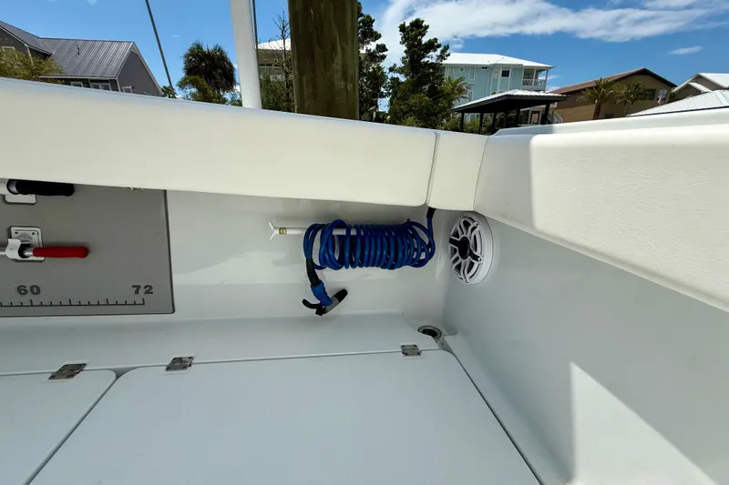 Slide: The Image of Interior view of 2023 Freeman 34VH boat with coiled blue hose and speaker. - 17
