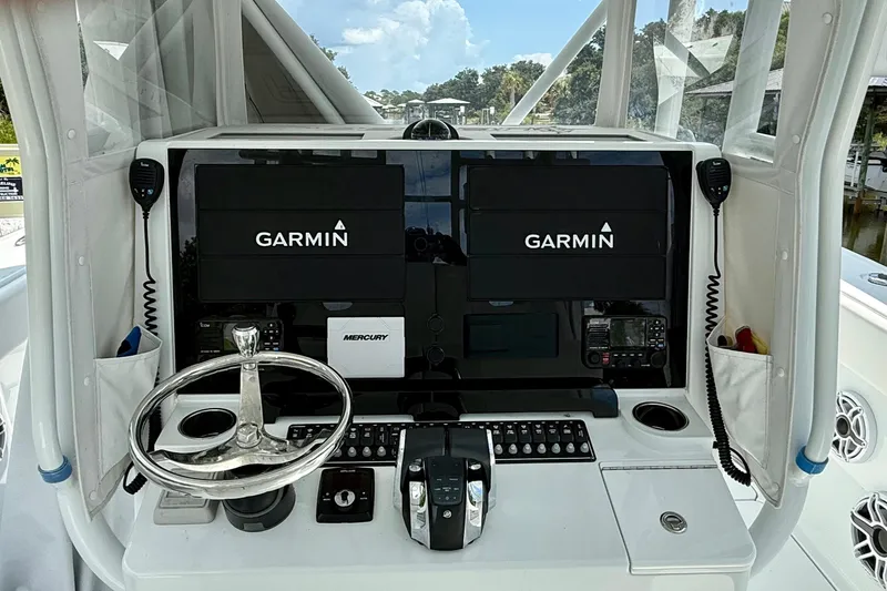Slide: The Image of 2023 Freeman 34VH boat dashboard with Garmin displays and Mercury controls. - 21