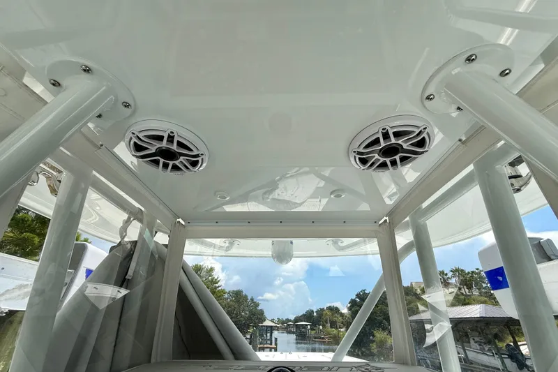 Slide: The Image of 2023 Freeman 34VH boat interior with speakers and scenic waterway view. - 24